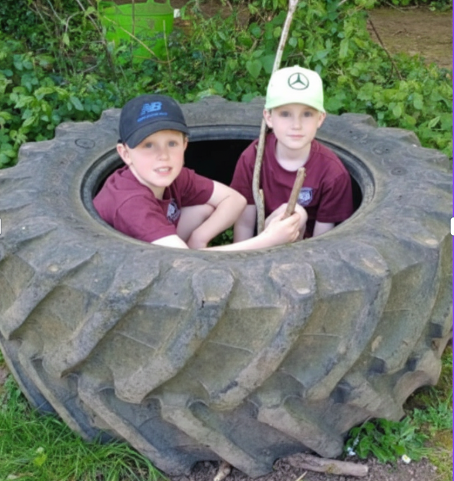 Two children in a tractor tyre